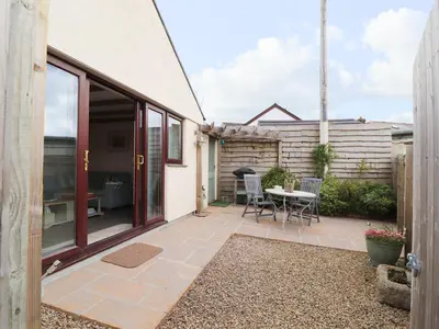 a small patio with a table and chairs on it at The Lily Pad in Camborne