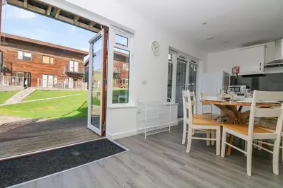 a kitchen and dining room with a table and chairs at Sea Breeze 17 Gannel in Truro