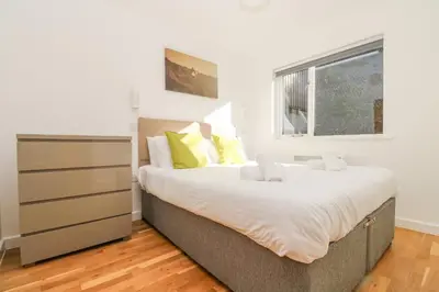 a bedroom with a large bed and a window at Sea Breeze 17 Gannel in Truro