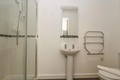 a bathroom with a sink and a shower at Sea Breeze 17 Gannel in Truro