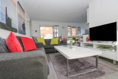 a living room with a couch and a tv at Sea Breeze 17 Gannel in Truro