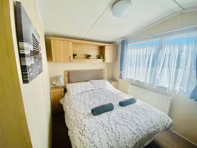 a small bedroom with a bed and a window at B47 Caravan Seven Bays in Padstow