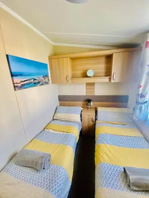 a room with three beds in a small room at B47 Caravan Seven Bays in Padstow