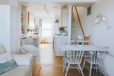 a kitchen and living room with a table and chairs at Falmouth View in Falmouth