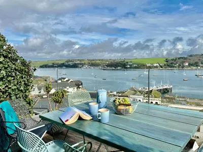 a picnic table with a view of a body of water at Jacob's View in Falmouth