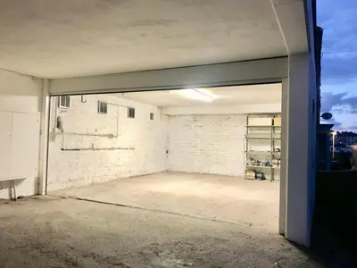 an empty garage with an open door at Jacob's View in Falmouth