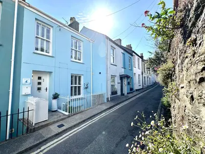 a street with blue and white houses on a hill at Jacob's View in Falmouth