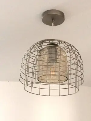 a metal bird cage hanging from a ceiling at Ocean View in Perranporth