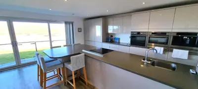 a kitchen with a counter and a table with chairs at Ocean View in Perranporth