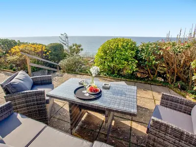 a table with a bowl of fruit on top of it at Hawks Ridge in Downderry