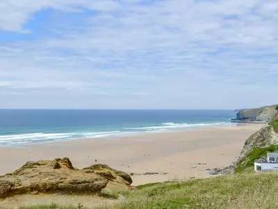 a beach with people on the sand and the ocean at Hen Harrier Lodge-Uc3979 in Saint Columb Major