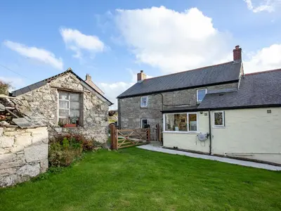 an old stone house with a gate and a yard at Greenbank Farm in Saint Dennis