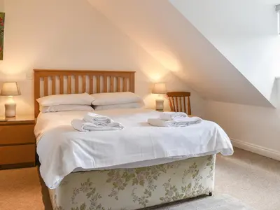 a bedroom with a bed with white sheets and pillows at Bunker - Uk11039 in Carlyon Bay