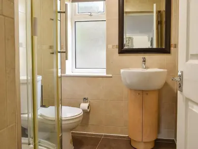 a bathroom with a sink and a toilet and a window at Bunker - Uk11039 in Carlyon Bay