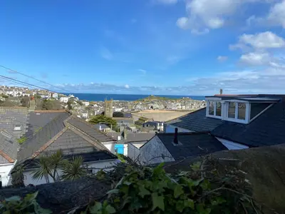 a view of a city with houses and the ocean at THE STONES St Ives Apartment Panoramic Harbour Views and Onsite Parking in St Ives