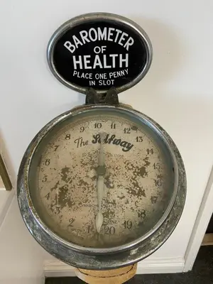 a clock with a sign on top of it at Huers Watch Beautiful Apartment with Panoramic Views over St Ives Bay and private parking in St Ives