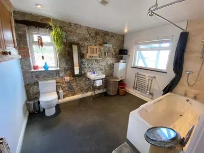 a bathroom with a toilet and a sink and a tub at Huers Watch Beautiful Apartment with Panoramic Views over St Ives Bay and private parking in St Ives