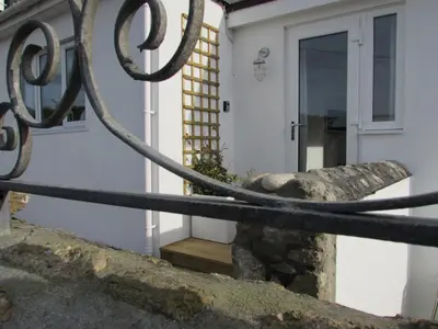 a wrought iron fence in front of a house at White Willows in Praa Sands