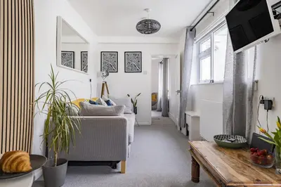a living room with a couch and a table at Waters Edge Holiday Home in Hayle, West Cornwall in Hayle