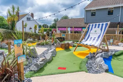 a yard with a chair and a lawn at Hendra Holiday Park in Newquay