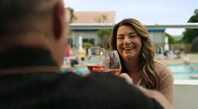 a man and a woman holding a glass of wine at Hendra Holiday Park in Newquay