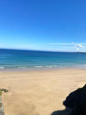 a sandy beach with the ocean in the background at Hendra Holiday Park in Newquay