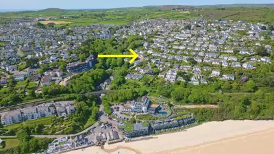an aerial view of a city with a yellow arrow on it at Little Coombe in St Ives