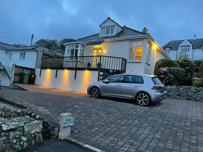 a silver car parked in front of a house at Little Coombe in St Ives