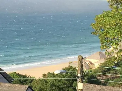 a view of the beach from a balcony at Little Coombe in St Ives