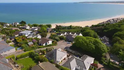 an aerial view of a houses and a beach at Little Coombe in St Ives