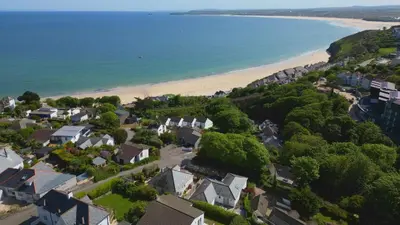 an aerial view of a town and a beach at Little Coombe in St Ives
