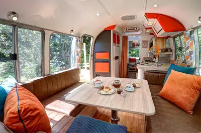 a dining area of an rv with a table at Glamping 1970 American Airstream motorhome in Ponsanooth