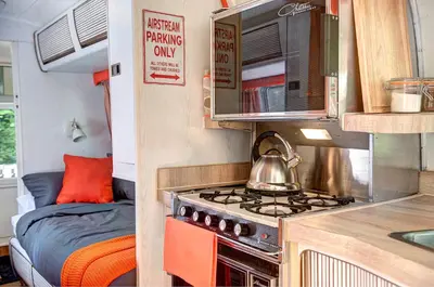 a kitchen with a tea kettle on a stove in an rv at Glamping 1970 American Airstream motorhome in Ponsanooth