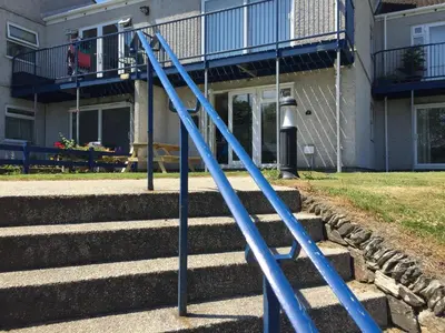 a set of blue poles in front of a building at Flat 7, Tremorvah Court in Falmouth