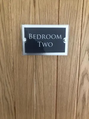 a sign on a wooden door with the words bedroom two at Flat 7, Tremorvah Court in Falmouth