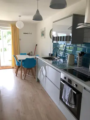 a kitchen with a table and a dining room at Flat 7, Tremorvah Court in Falmouth