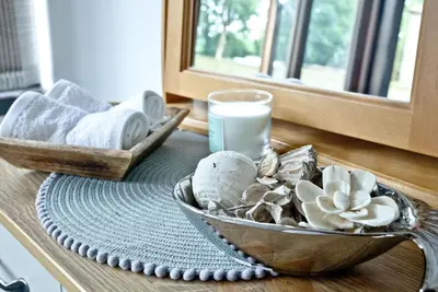 a table with a bowl of shells and a glass of milk at The Barn in Lanhydrock, Bodmin in Bodmin