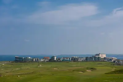 a golf course with a city in the background at 5 The Vista, Newquay - Short Walk to Beach - Free Parking and Wi-Fi - Stunning Views in Newquay