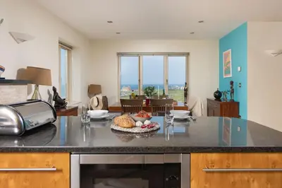 a kitchen with a counter with a bowl of fruit on it at 5 The Vista, Newquay - Short Walk to Beach - Free Parking and Wi-Fi - Stunning Views in Newquay