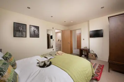 a bedroom with a large bed and a television at 5 The Vista, Newquay - Short Walk to Beach - Free Parking and Wi-Fi - Stunning Views in Newquay