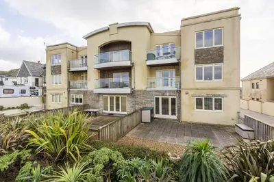 an apartment building with a patio and plants at 5 The Vista, Newquay - Short Walk to Beach - Free Parking and Wi-Fi - Stunning Views in Newquay