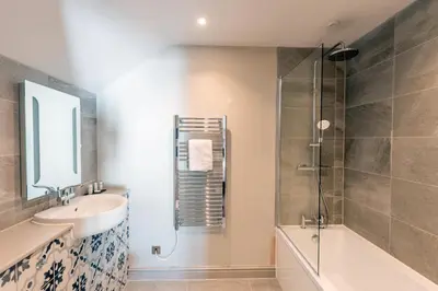 a bathroom with a sink and a shower at The Inn on the Shore in Torpoint