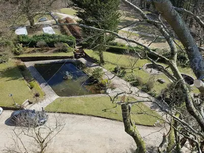 an aerial view of a garden with a pond at Great Trethew Manor Hotel & Restaurant in Menheniot