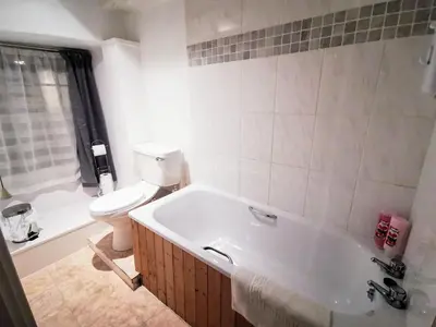 a bathroom with a bath tub and a toilet at The Darlington Hotel in Camelford