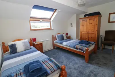 a bedroom with two beds and a window at TOWN CENTRE apartment dogs welcome in Padstow