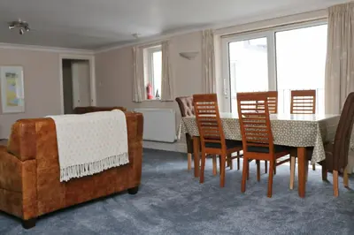 a dining room with a table and chairs at TOWN CENTRE apartment with parking in Padstow