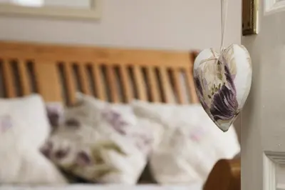 a heart hanging on a door with a bed at TOWN CENTRE apartment with parking in Padstow