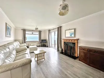 a living room with a couch and a fireplace at Porthleven Coastal Retreat with 5 Bedrooms in Porthleven