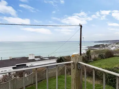 a view of the ocean from the balcony of a house at Porthleven Coastal Retreat with 5 Bedrooms in Porthleven