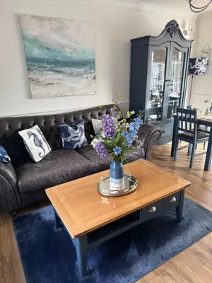 a living room with a couch and a coffee table at Downsfield Bed and Breakfast in St Ives
